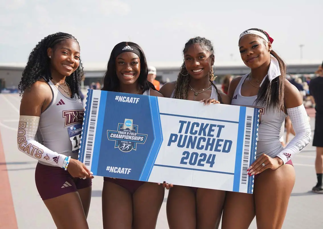 Four female runners holding a ncaatf sign