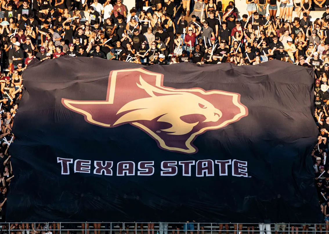 Full stands holding Texas State flag